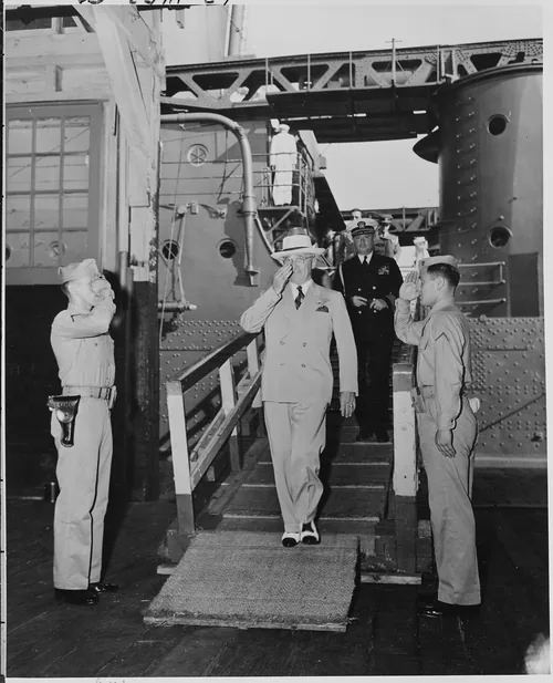 President Harry S. Truman leaves the U. S. S. Augusta at Newport News, Virginia at the end of his voyage home on the